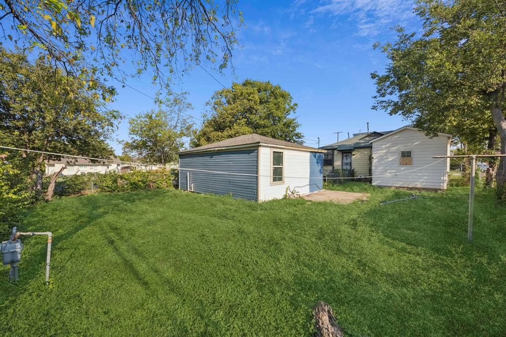 3228 Emmett Street Dallas, TX 75211 - Photo 23 of 25 a backyard of a house with plants and large tree