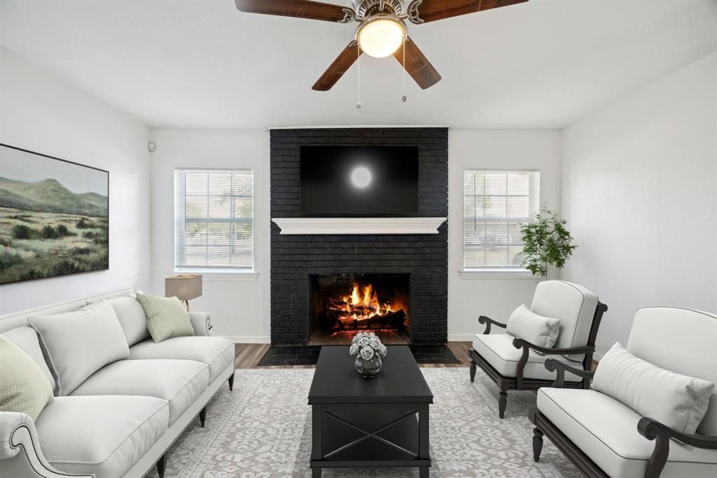 3228 Emmett Street Dallas, TX 75211 - Photo 3 of 25 a living room with furniture a fireplace and a flat screen tv