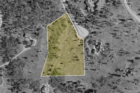 a view of an aerial view of residential houses with outdoor space and mountain view