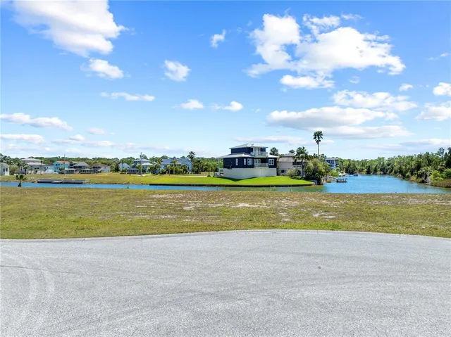 a view of a lake with houses in the back