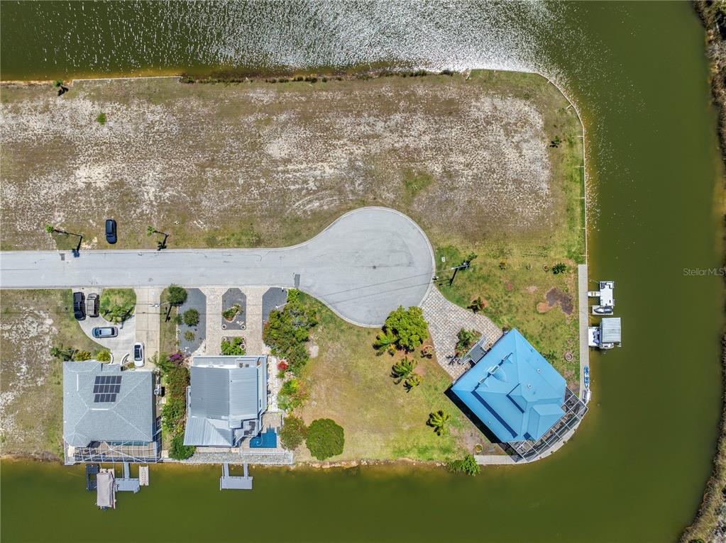 3336 Croaker Drive, Unit LOT 36 Hernando Beach, FL 34607 - Photo 3 of 20 an aerial view of a house with a yard and lake view