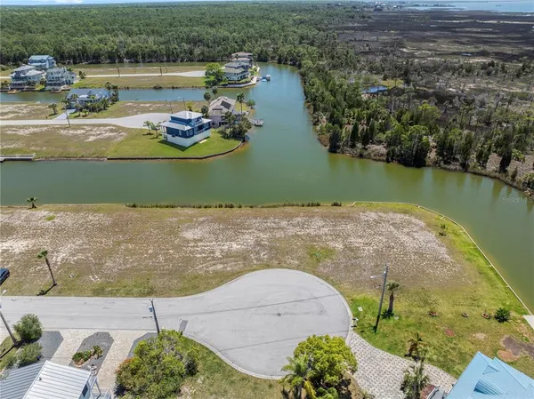 an aerial view of a house with a lake view