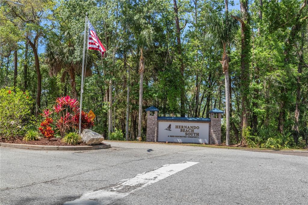 3336 Croaker Drive, Unit LOT 36 Hernando Beach, FL 34607 - Photo 10 of 20 a street sign on the side of the road