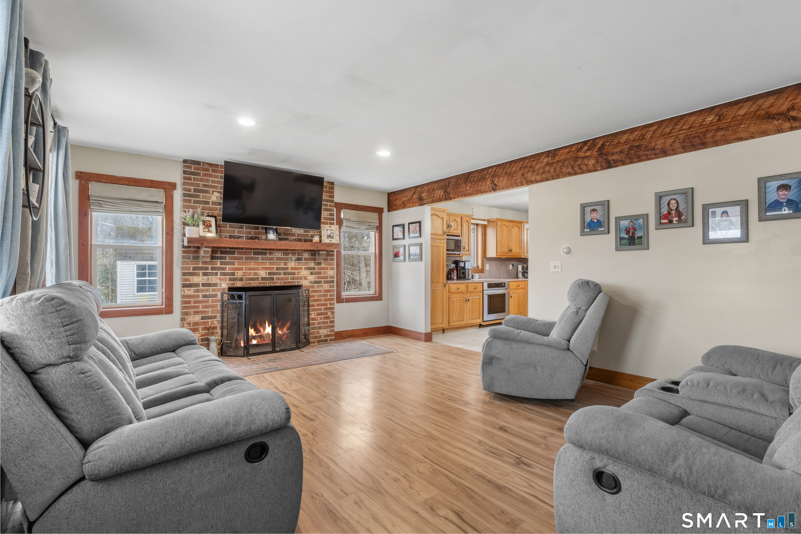 120 Hanover Versailles Road Sprague, CT 06330 - Photo 4 of 26 a living room with furniture a flat screen tv and a fireplace
