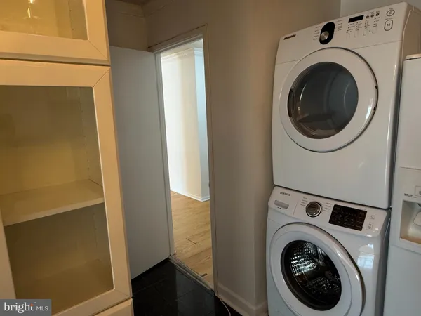 a view of an empty room with door with wooden floor and windows