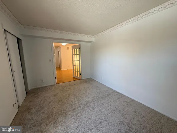 a view of a glass door with a tv from a window