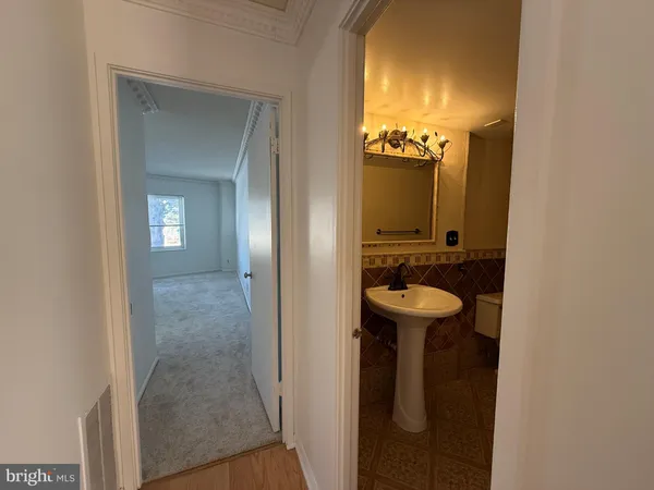 a bathroom with a sink mirror bathtub and toilet