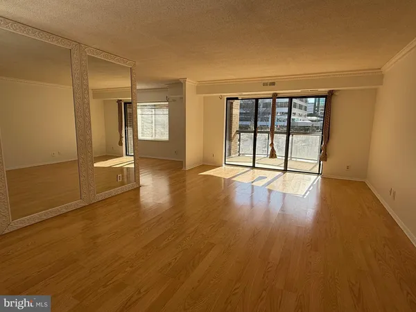 a view of a balcony with wooden floor and iron stairs