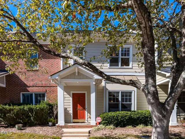 front view of a house with a tree