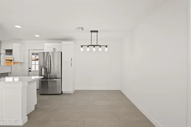 an empty room with a kitchen and a sink