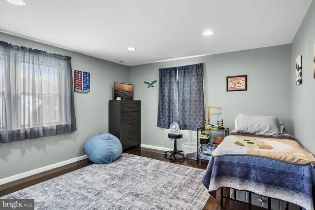 a bedroom with bed and a window