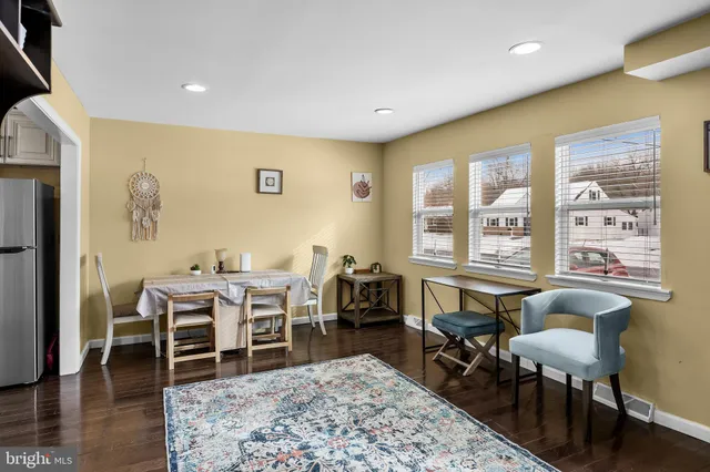 a living room with furniture a rug and a large window