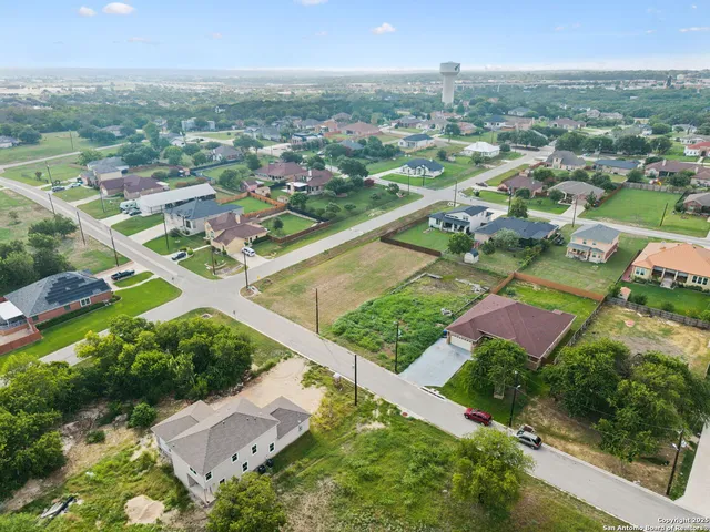 an aerial view of residential houses with outdoor space