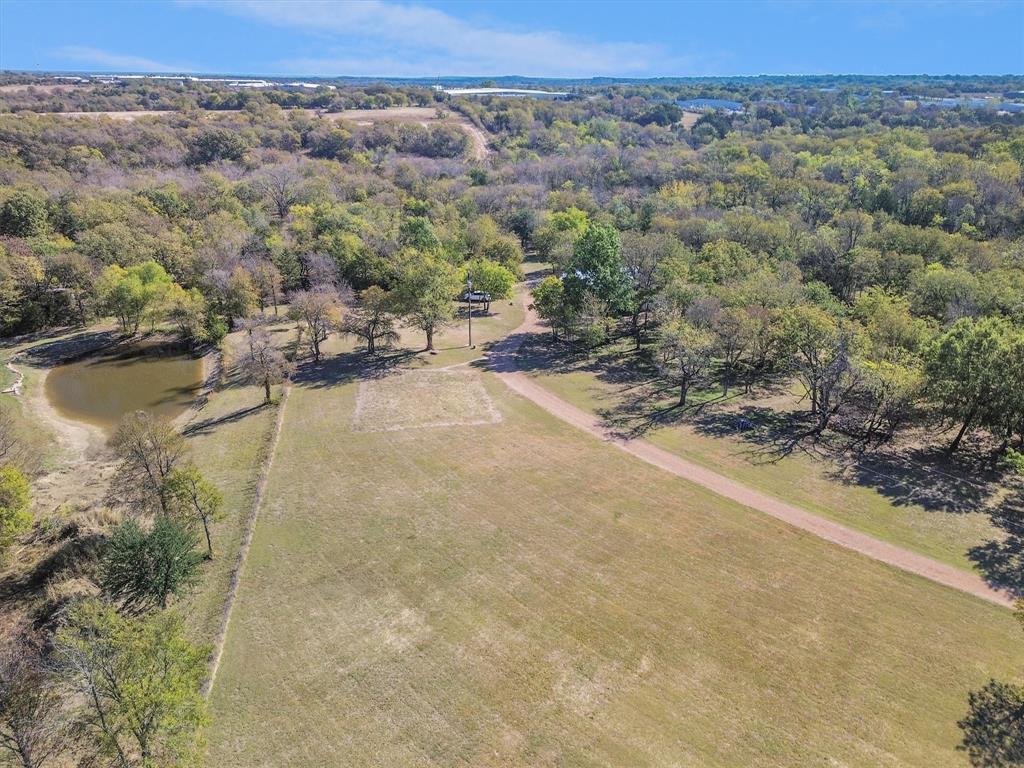 an aerial view of a house with a yard and lake view