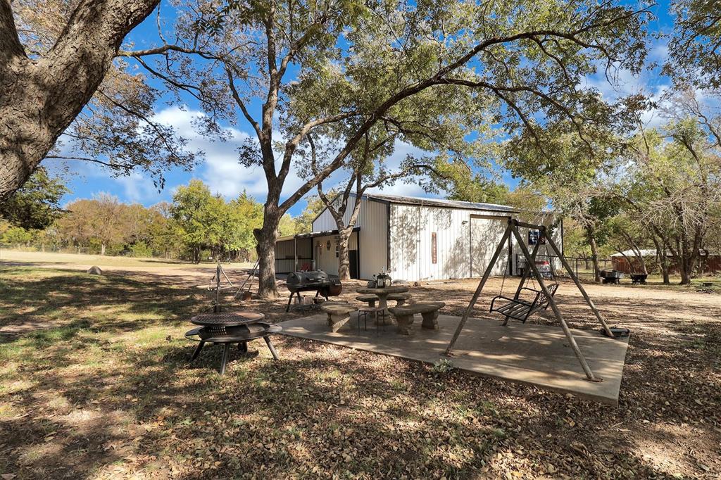 2601 Randell Lake Road Denison, TX 75020 - Photo 20 of 40 a backyard of a house with table and chairs