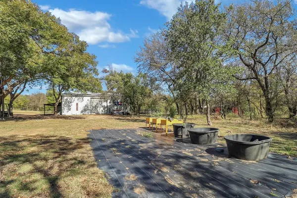 a view of a large yard with lots of green space