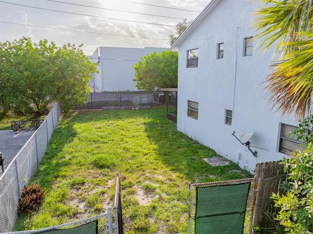 a view of backyard with plants and outdoor seating