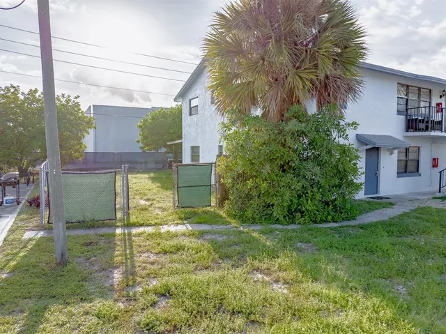 a front view of a house with a yard and a garage