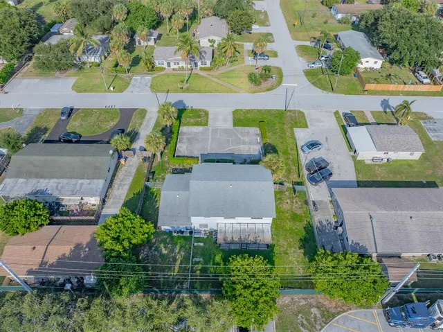 an aerial view of residential houses with outdoor space and ocean view
