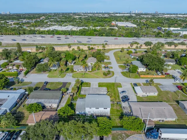an aerial view of a house with a garden and large trees