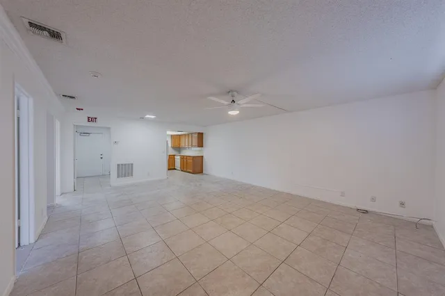 an empty room with a empty space and windows