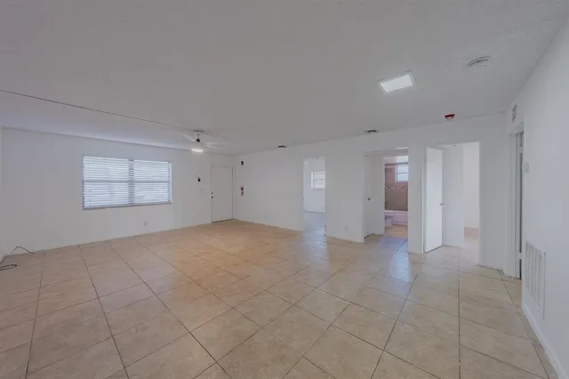 an empty room with entrance and windows