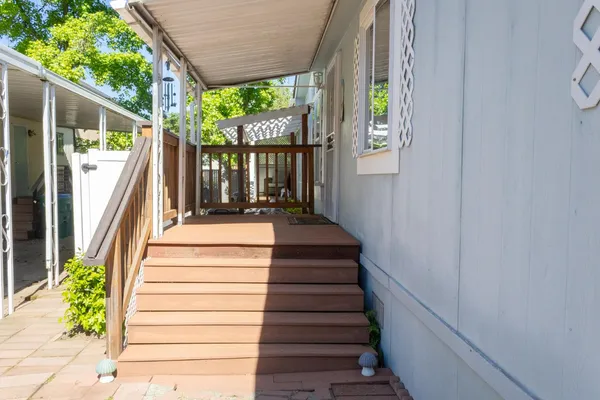 a view of a balcony with wooden floor and stairs