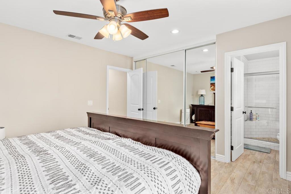 262 Chapalita Drive Encinitas, CA 92024 - Photo 16 of 30 a bedroom with a bed and a walk in closet