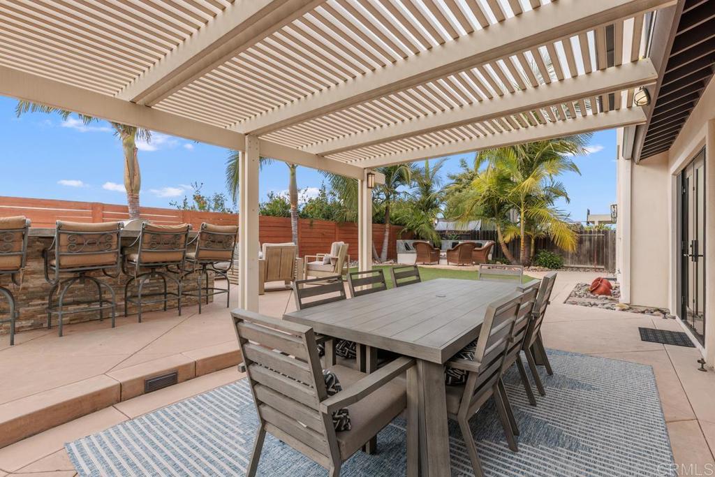 262 Chapalita Drive Encinitas, CA 92024 - Photo 19 of 30 a view of a patio with table and chairs and wooden floor