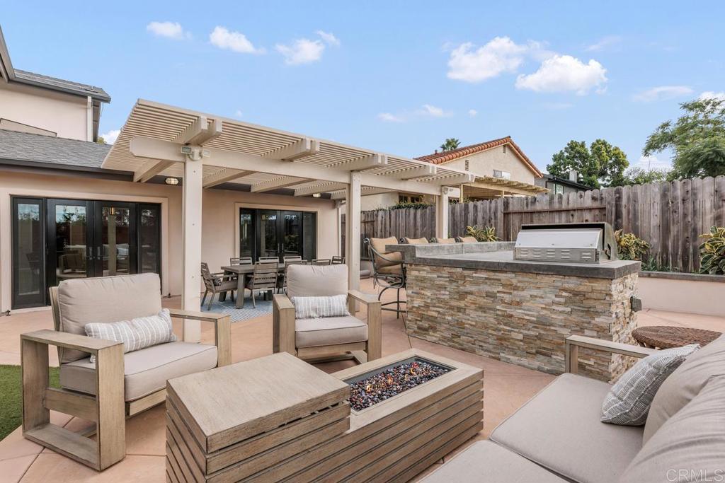 262 Chapalita Drive Encinitas, CA 92024 - Photo 20 of 30 a view of a patio with couches table and chairs with wooden floor and fence