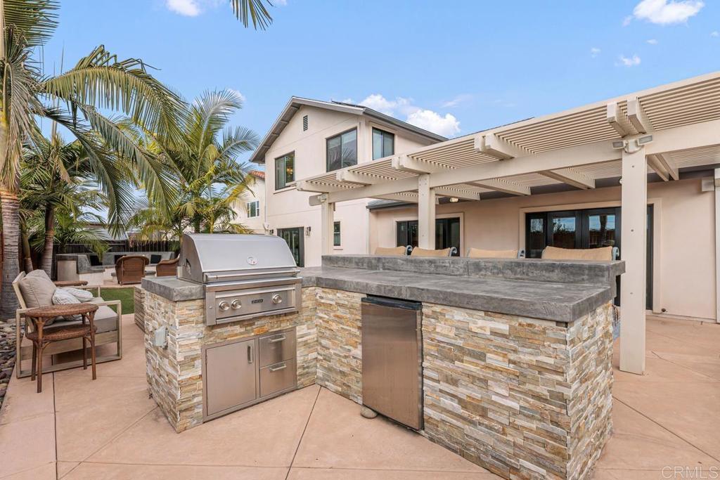 262 Chapalita Drive Encinitas, CA 92024 - Photo 23 of 30 a kitchen with a stove and a microwave oven on the wall