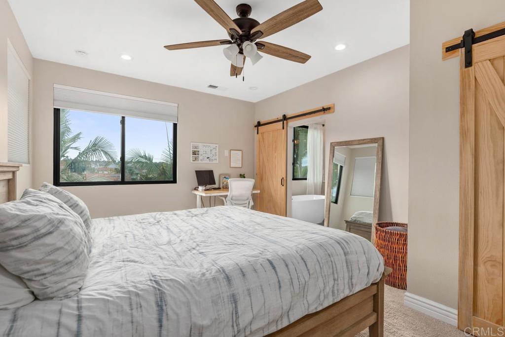 262 Chapalita Drive Encinitas, CA 92024 - Photo 25 of 30 a bedroom with a large bed and a painting on the wall