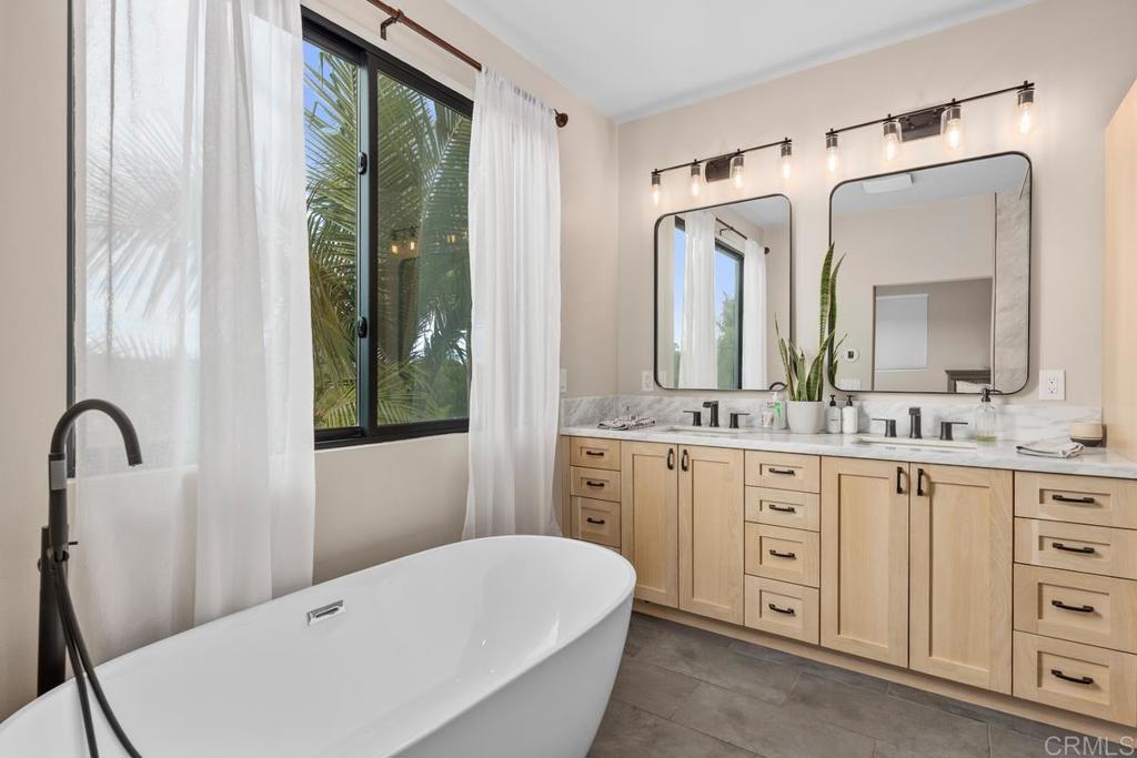 262 Chapalita Drive Encinitas, CA 92024 - Photo 26 of 30 a bathroom with a double vanity sink mirror and bathtub