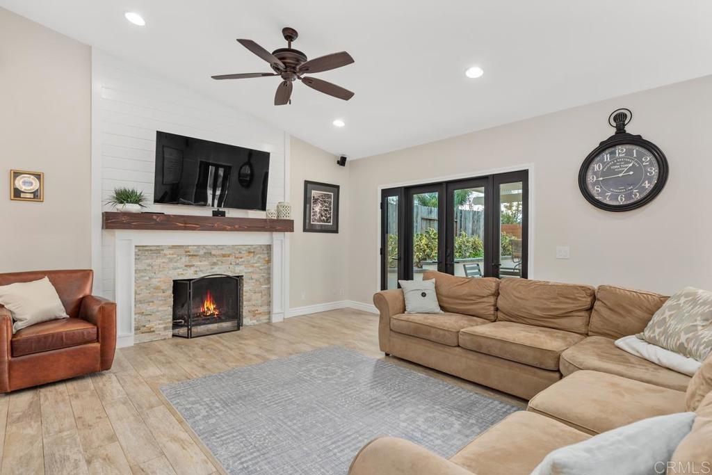 262 Chapalita Drive Encinitas, CA 92024 - Photo 6 of 30 a living room with furniture a fireplace and a flat screen tv