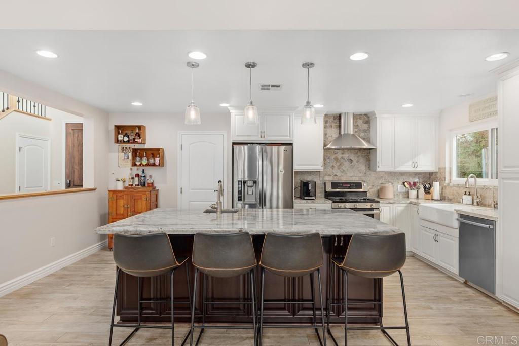 262 Chapalita Drive Encinitas, CA 92024 - Photo 8 of 30 a kitchen with a dining table chairs and wooden floor