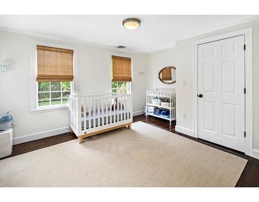 a view of an empty room with a window and closet area