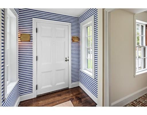 a view of a bedroom with wooden floor and windows