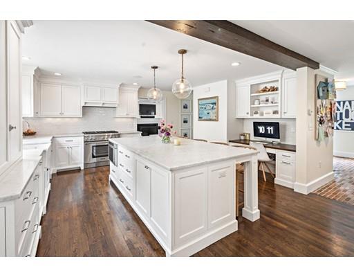 50 Garrison Road Hingham, MA 02043 - Photo 6 of 30 a kitchen with white cabinets stainless steel appliances and wooden floor