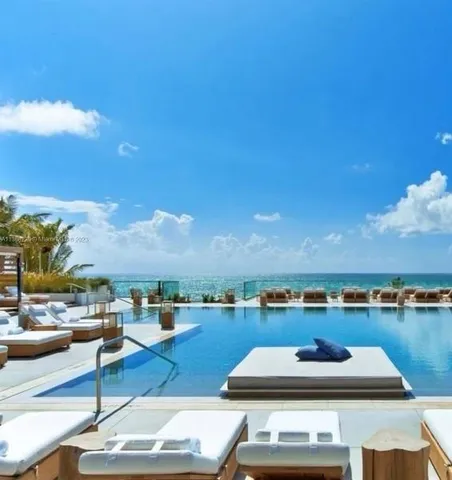 a view of a swimming pool and lounge chairs