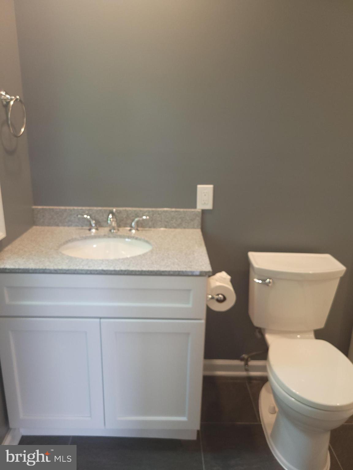 2250 North Quantico Street Arlington, VA 22205 - Photo 14 of 47 a bathroom with a granite countertop toilet and a sink