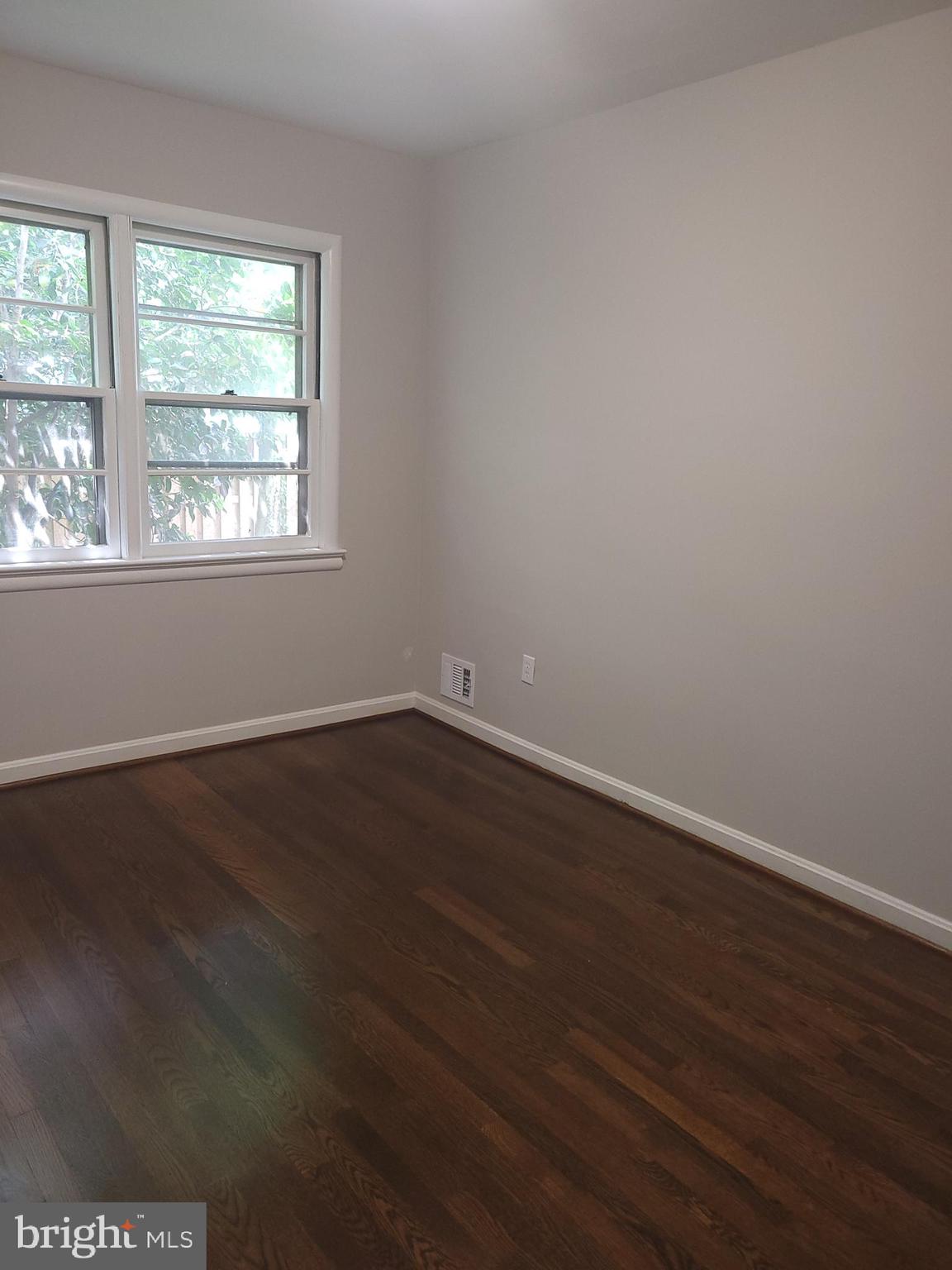 2250 North Quantico Street Arlington, VA 22205 - Photo 20 of 47 an empty room with wooden floor and windows
