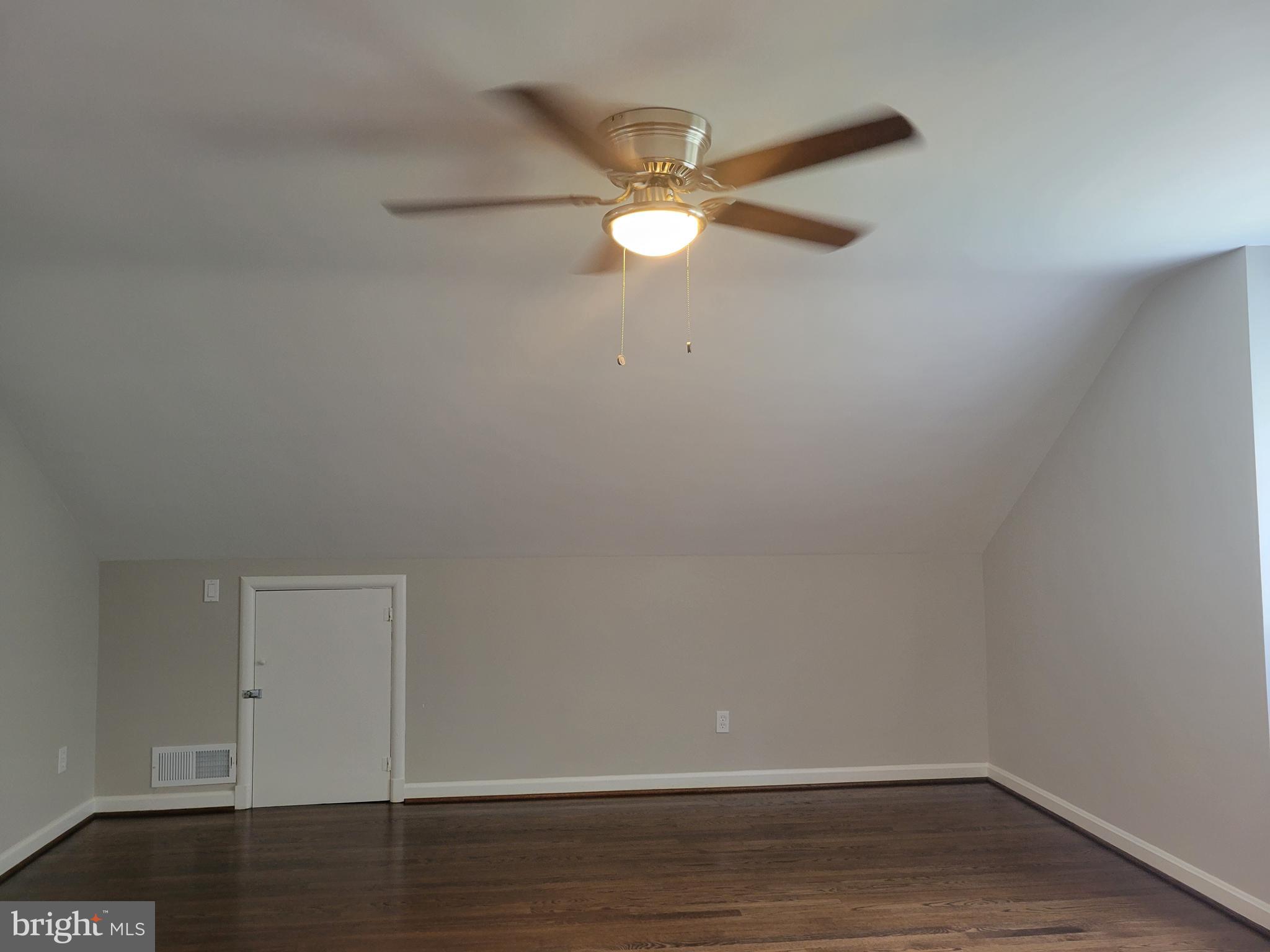 2250 North Quantico Street Arlington, VA 22205 - Photo 28 of 47 a view of an empty room with wooden floor and a ceiling fan