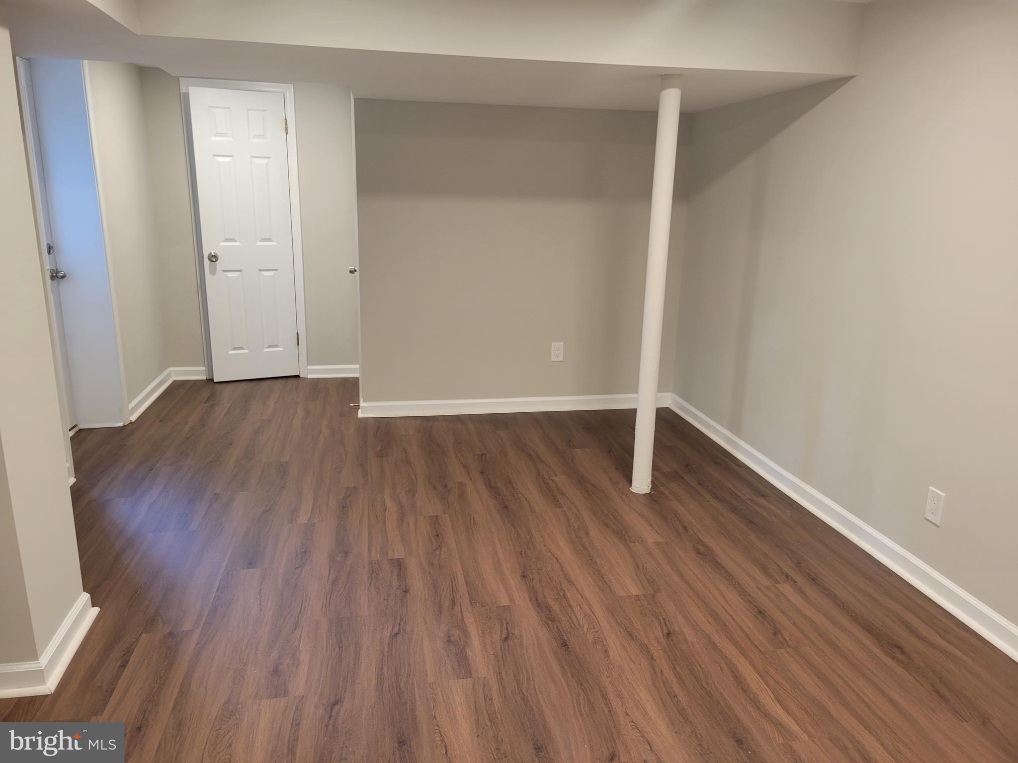 2250 North Quantico Street Arlington, VA 22205 - Photo 35 of 47 a view of an empty room with wooden floor and a window