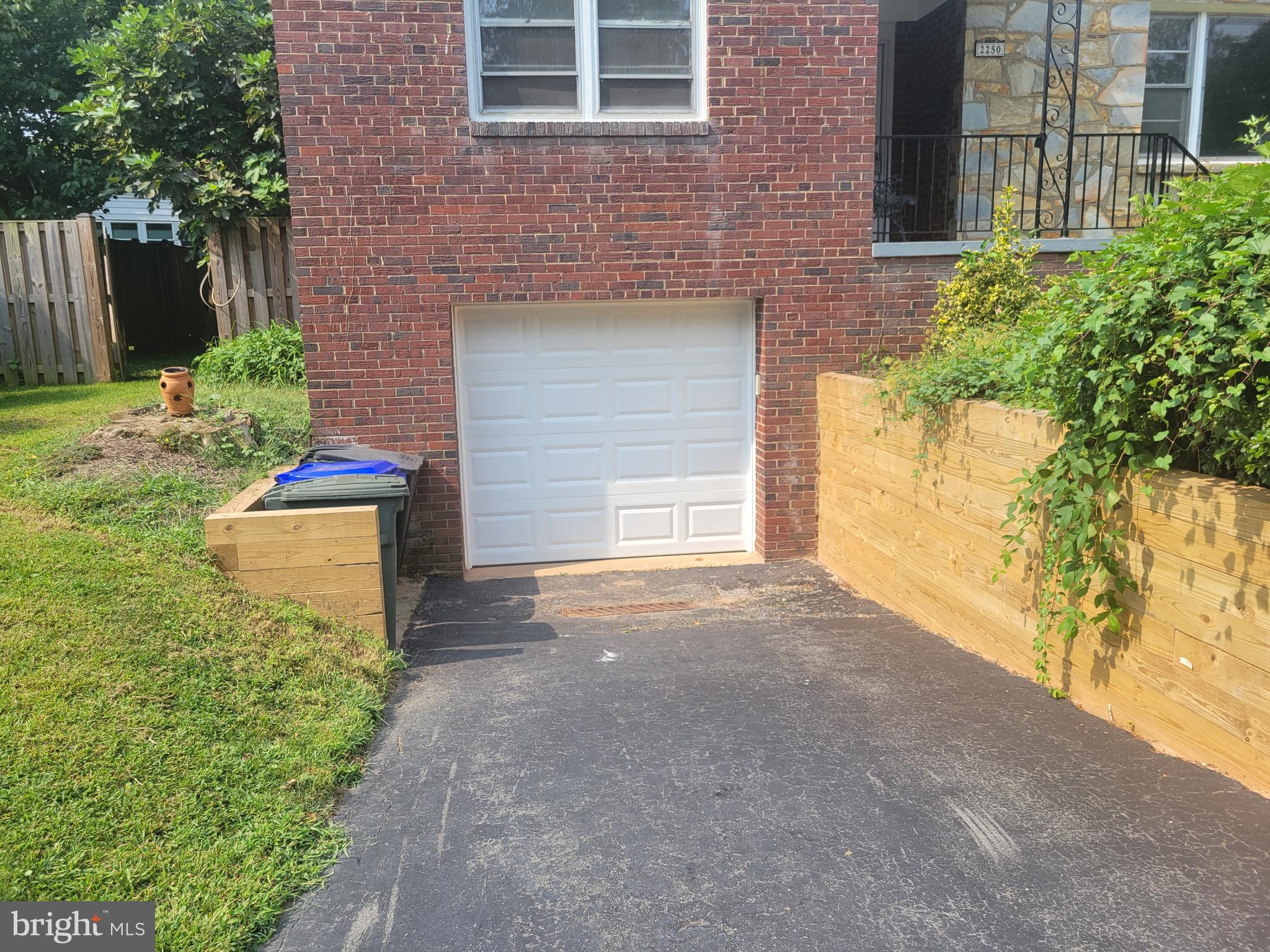 2250 North Quantico Street Arlington, VA 22205 - Photo 46 of 47 a front view of a house with a yard and garage
