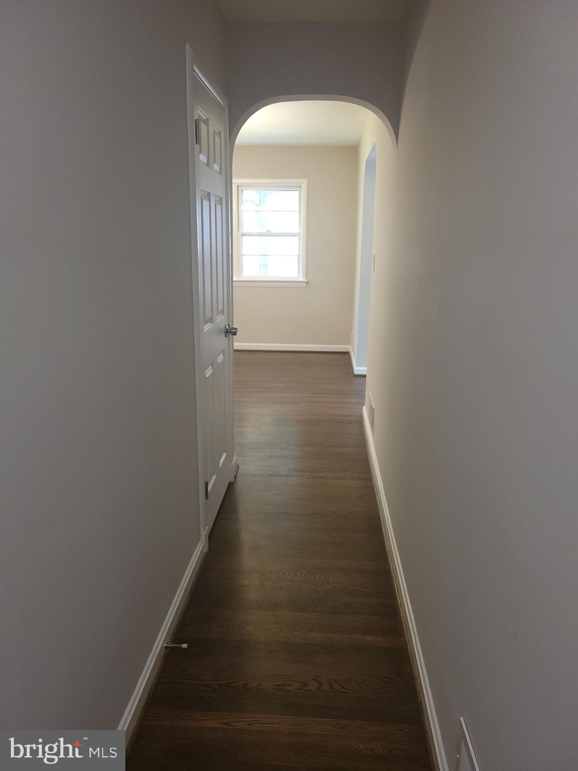 2250 North Quantico Street Arlington, VA 22205 - Photo 6 of 47 a view of a hallway with wooden floor and staircase