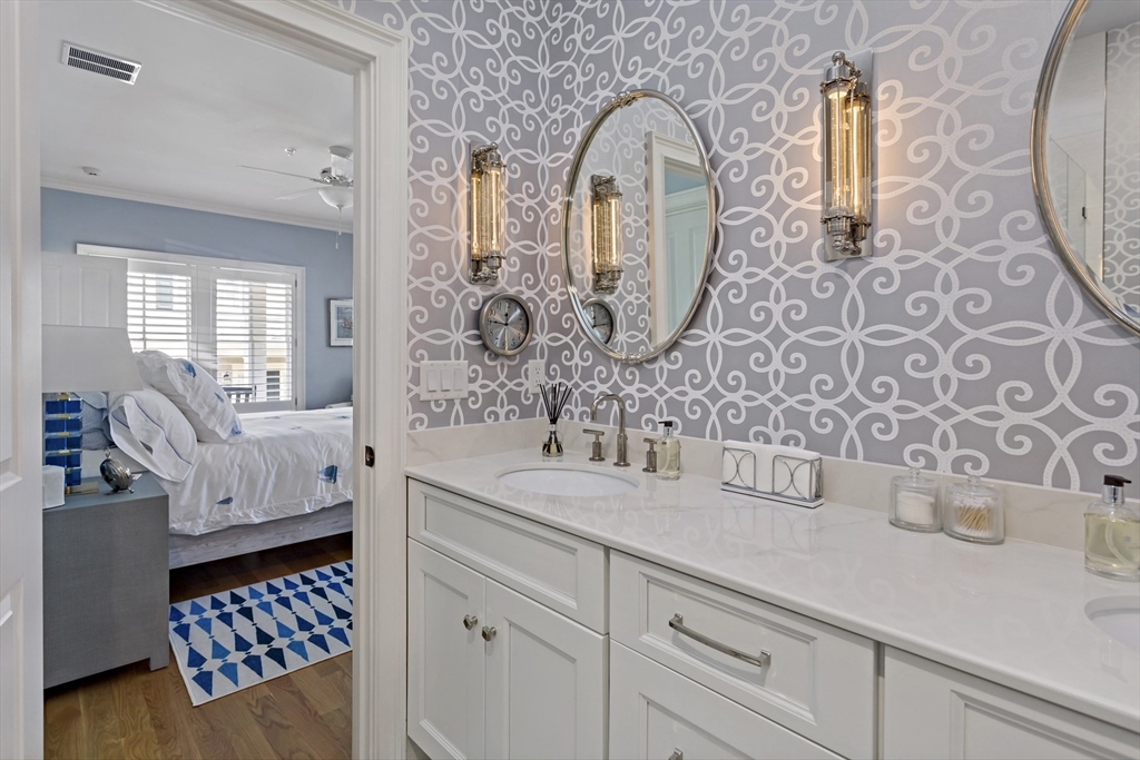1090 Shore Road, Unit 4 Bourne, MA 02559 - Photo 16 of 42 a spacious bathroom with a double vanity sink and a mirror
