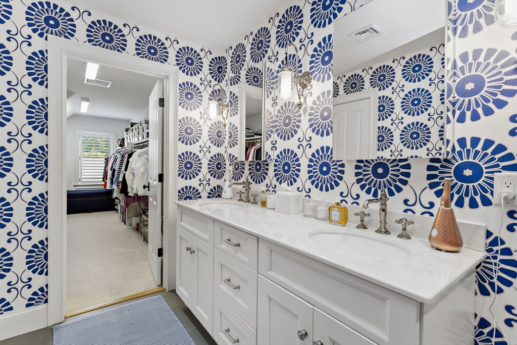 1090 Shore Road, Unit 4 Bourne, MA 02559 - Photo 27 of 42 a bathroom with a sink and mirror with shower