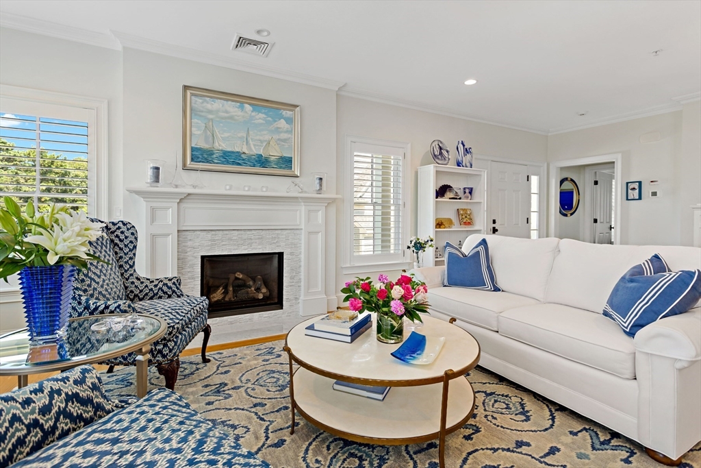 1090 Shore Road, Unit 4 Bourne, MA 02559 - Photo 8 of 42 a living room with furniture and a fireplace