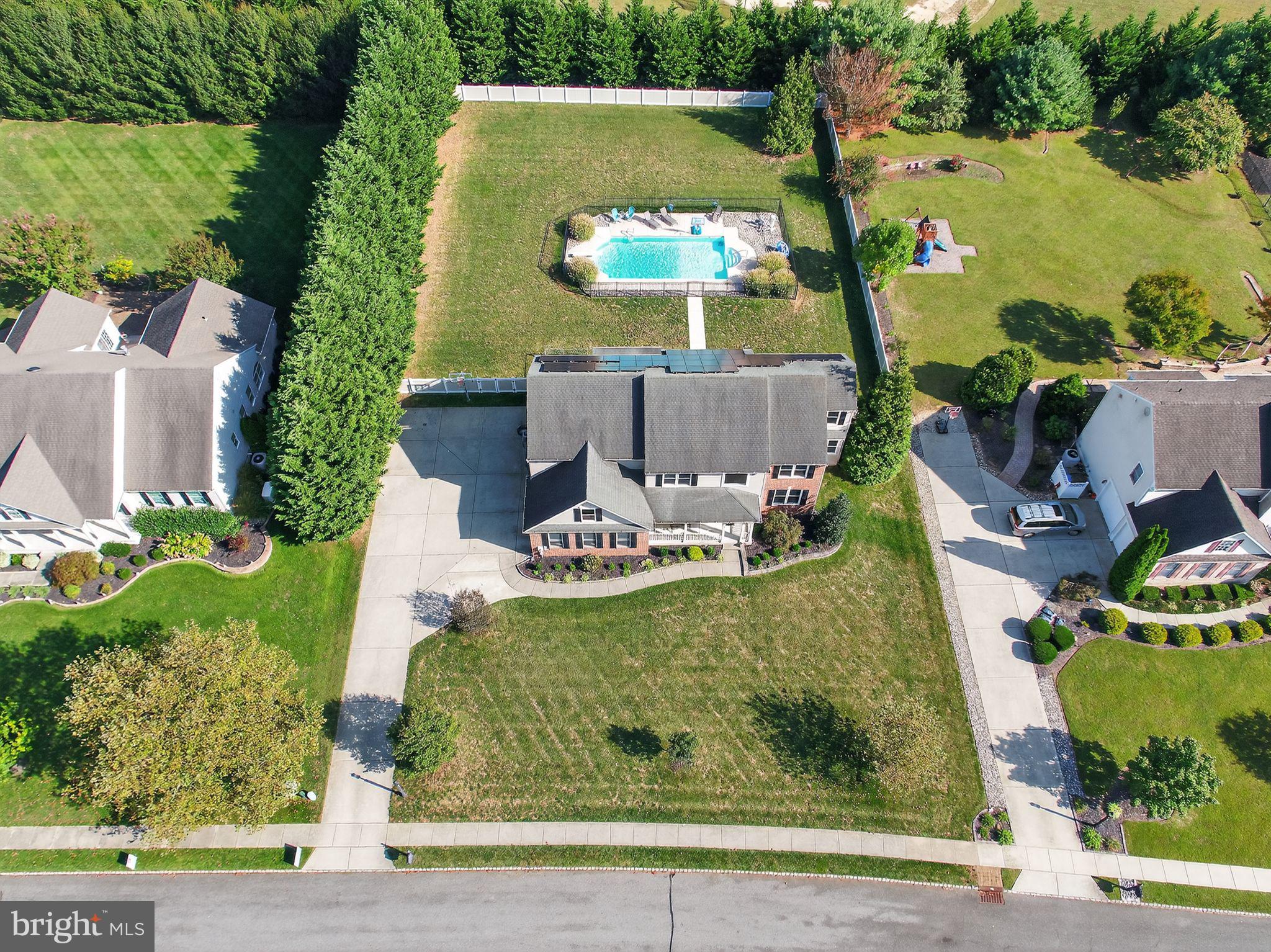 an aerial view of a house with a yard basket ball court and outdoor seating