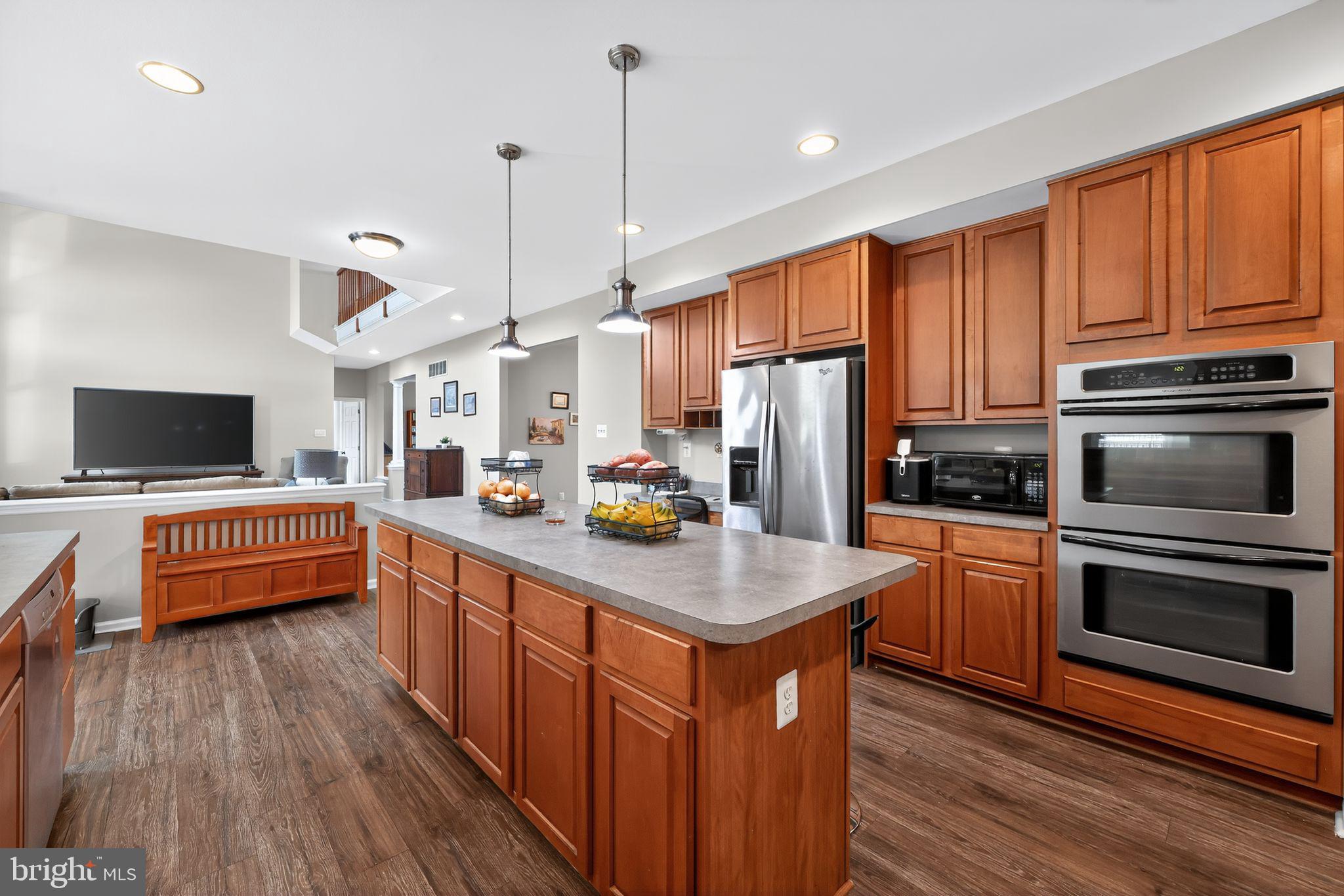 562 Partridge Court Mickleton, NJ 08056 - Photo 12 of 33 a kitchen with stainless steel appliances granite countertop a stove a sink dishwasher and a refrigerator with wooden floor